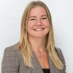 A professional portrait of MacKenzie Gunther, the First Officer of Air Canada Express Flight 8646, smiling and wearing a grey checkered blazer.